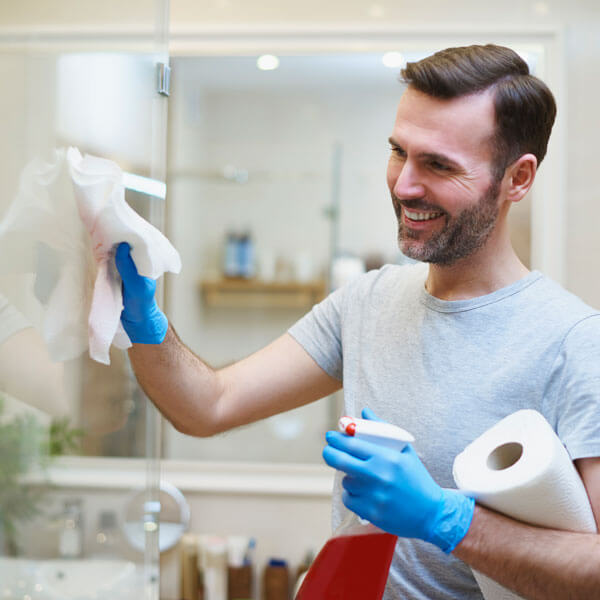 A man meticulously cleaning glass for a clear view.