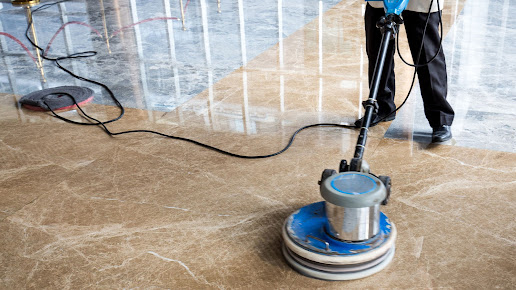 Man Cleaning the floor using equipment