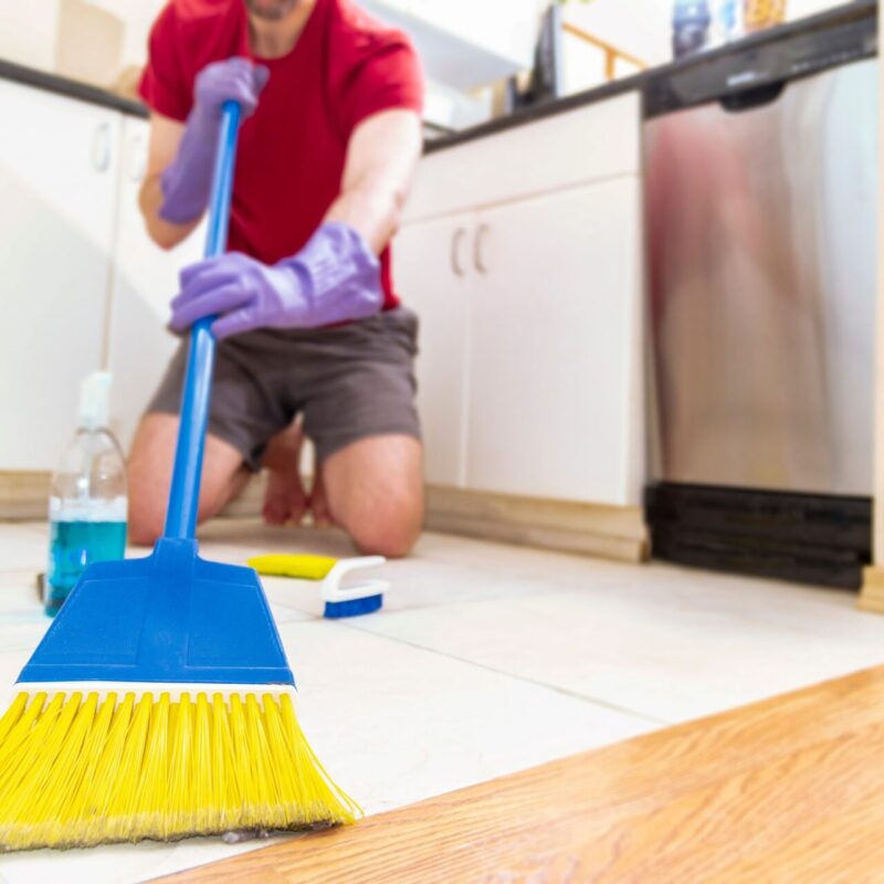 Person cleaning with broom